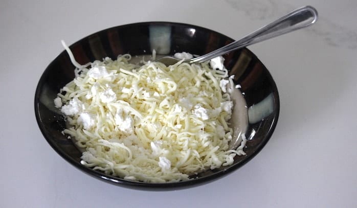 A bowl of cheese for the cheese buns recipe
