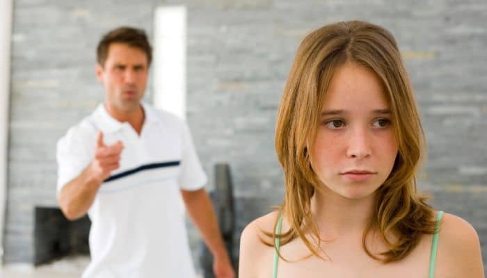 Dad scolding teenage girl for not doing household chores