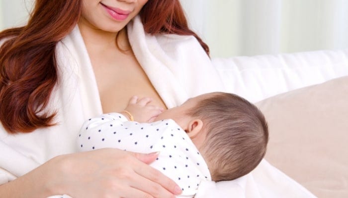 a mom breastfeeding her child