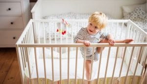 baby crawling out of the crib