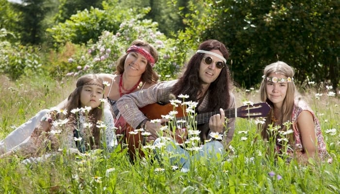 hippie family sitting in the meadow