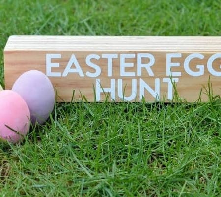 a sign on the grass saying Easter egg hunt