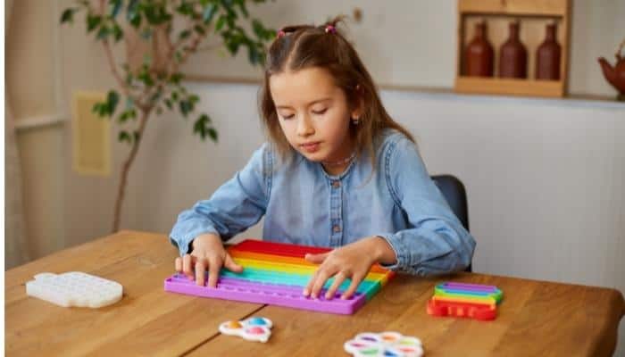 a girl playing with sensory toy