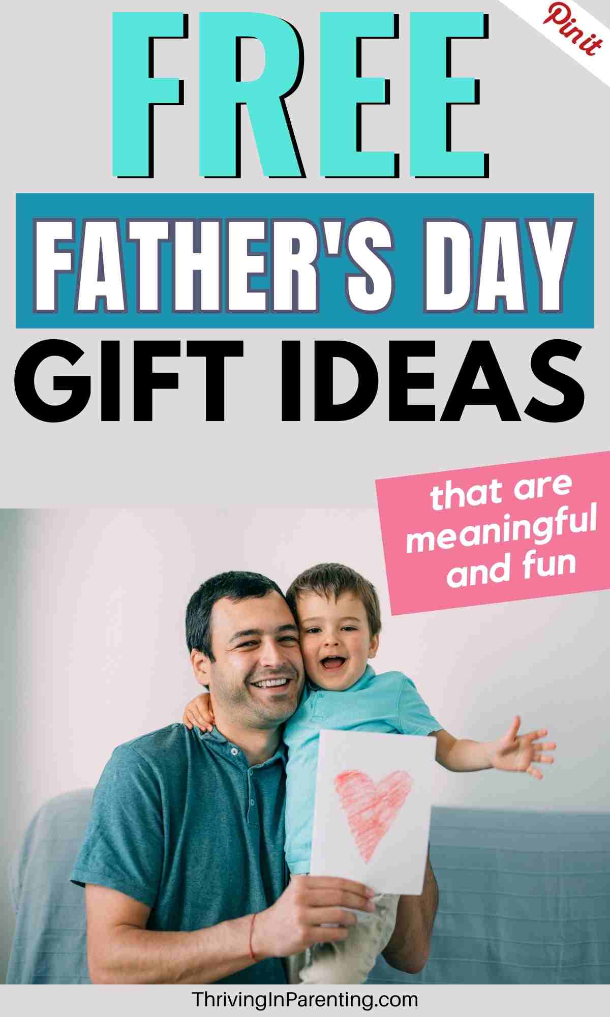 a father holding his little son with a handmade free father's day card in his hand