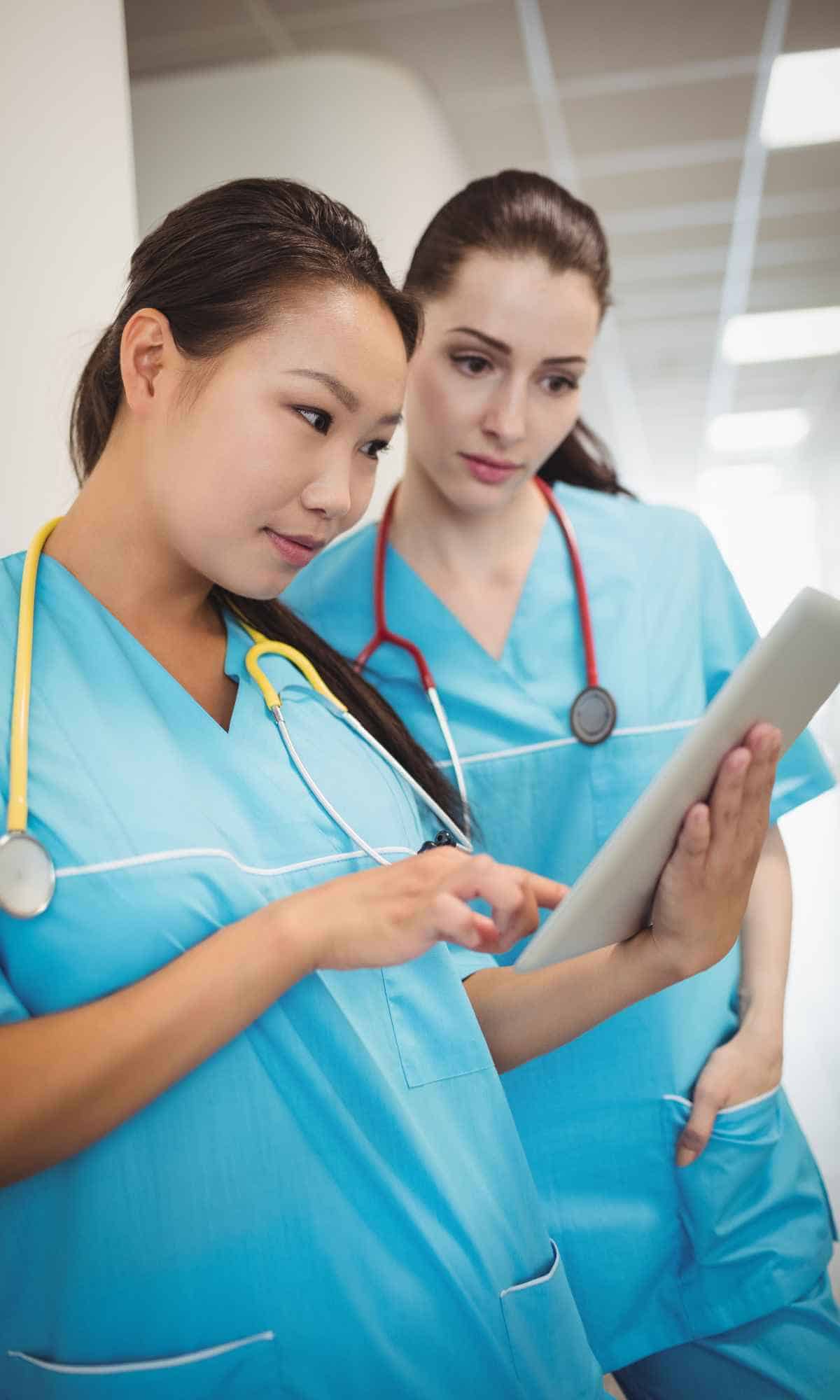 labor and delivery nurses looking at expectant mom's file