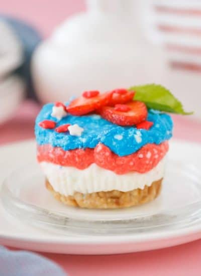 nicely decorated red white and blue mini cheesecake on a plate