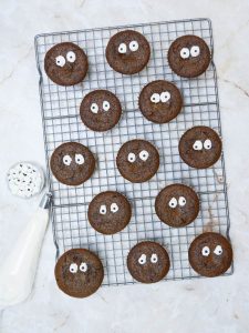 Brownie cookies with eyes on a cooling rack.