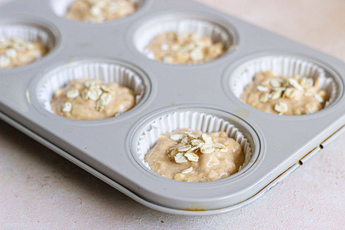 A muffin tin filled with muffin batter.