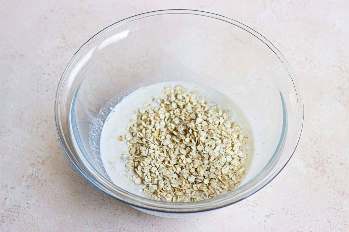 Oats, milk, and flour in a glass bowl.
