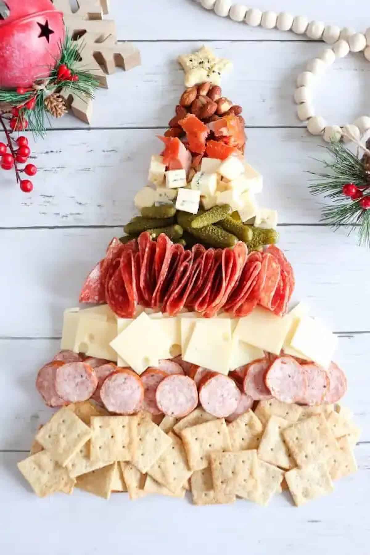 A Christmas tree made out of crackers, cheese, and meat.