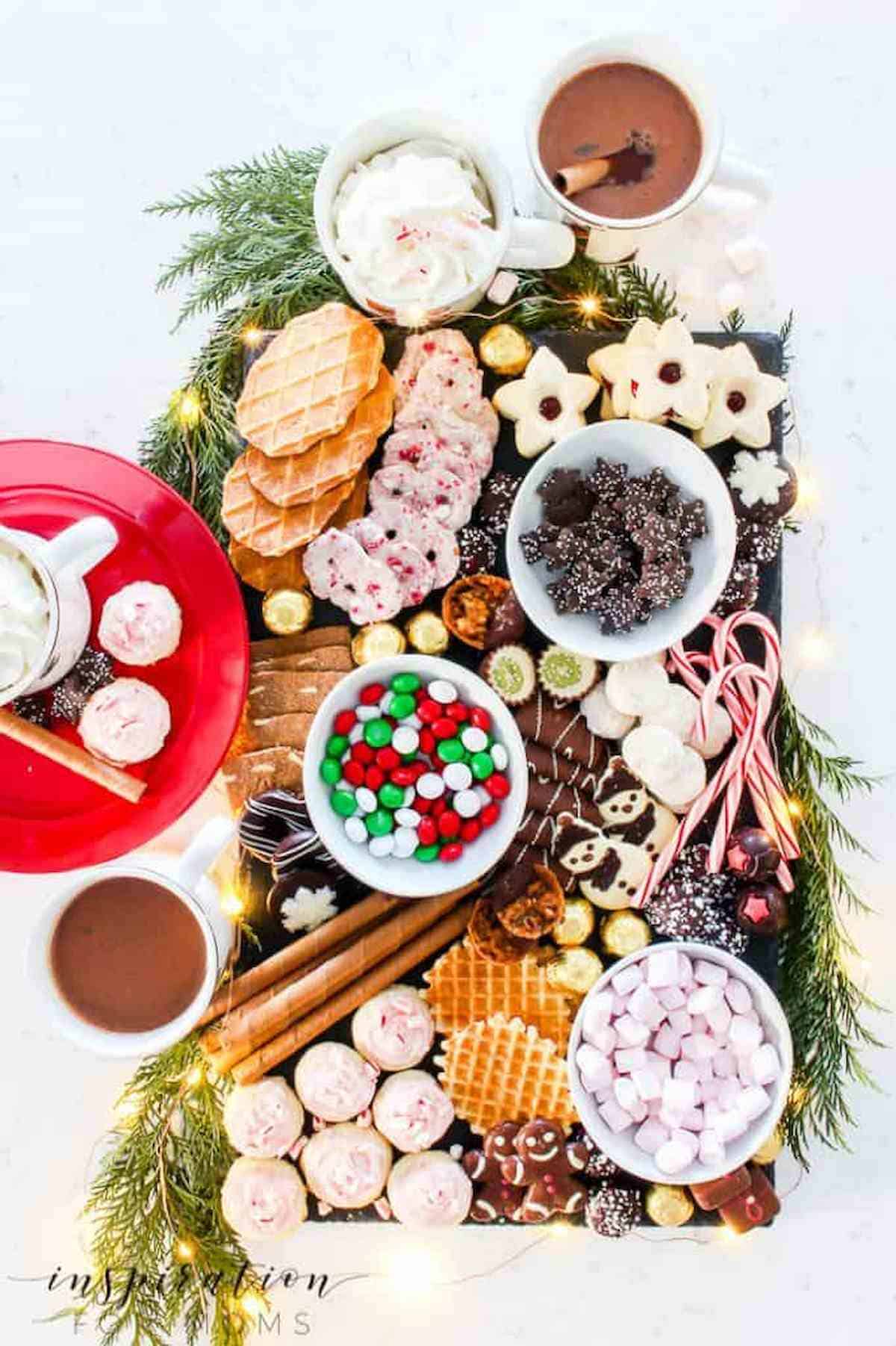 A Christmas dessert tray with cookies and candies.