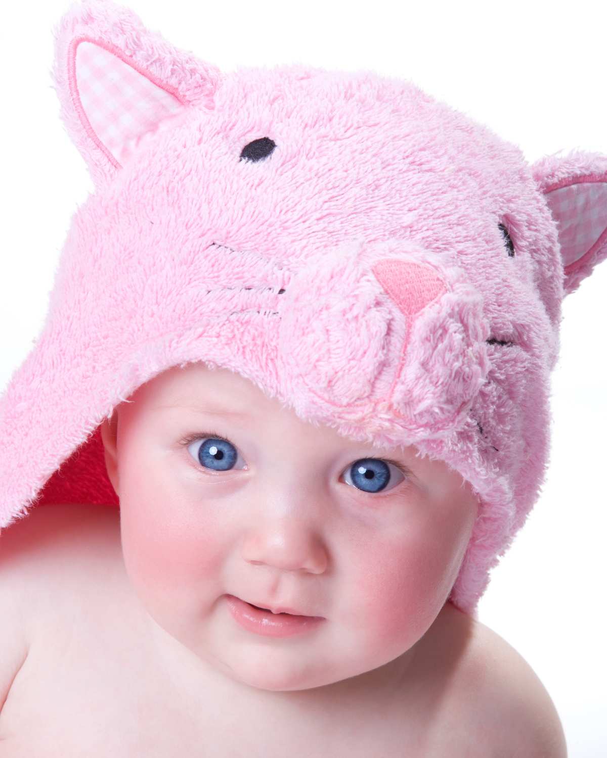 A baby wearing a pink bunny towel.