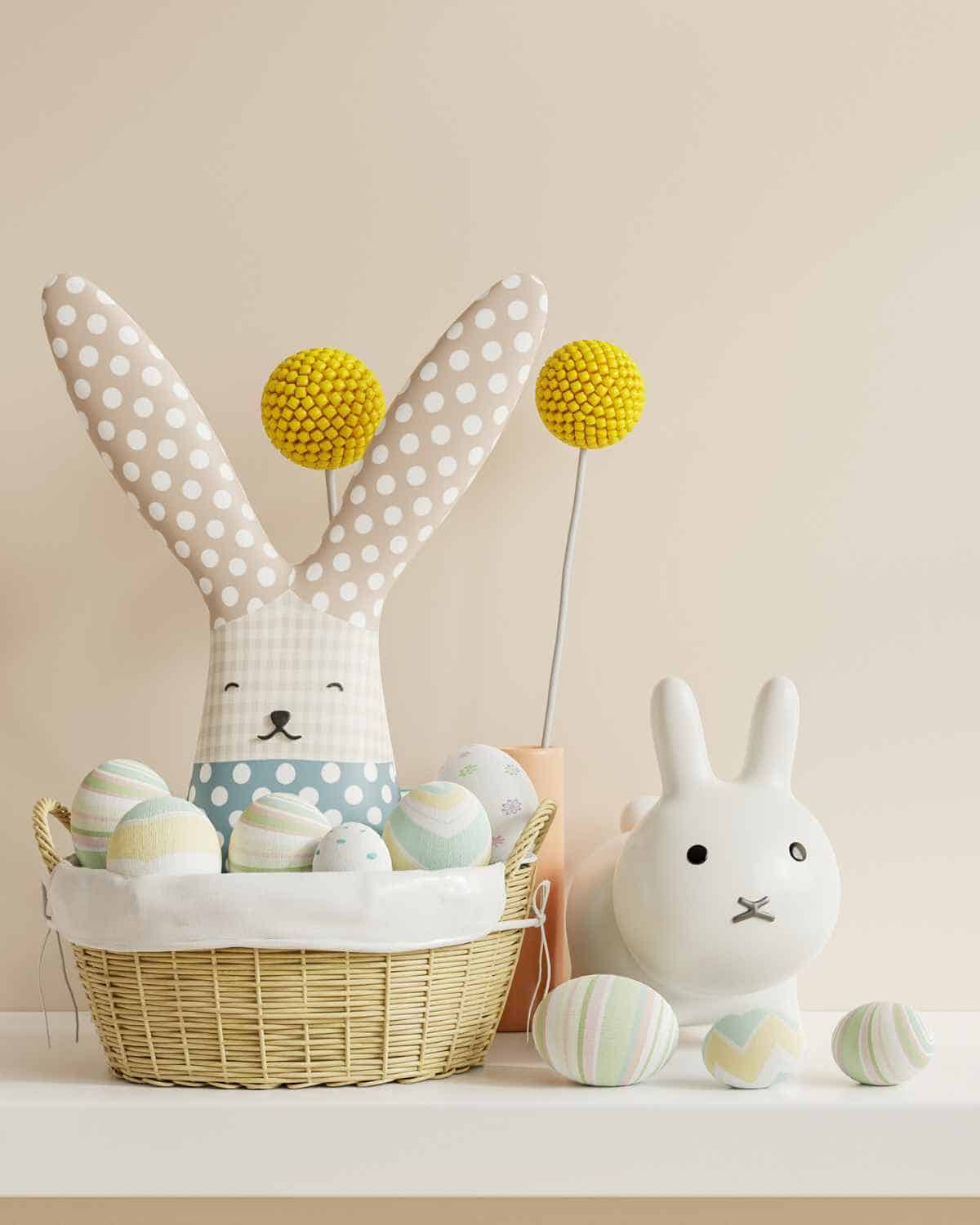 Easter bunny and Easter eggs in a basket on a table.