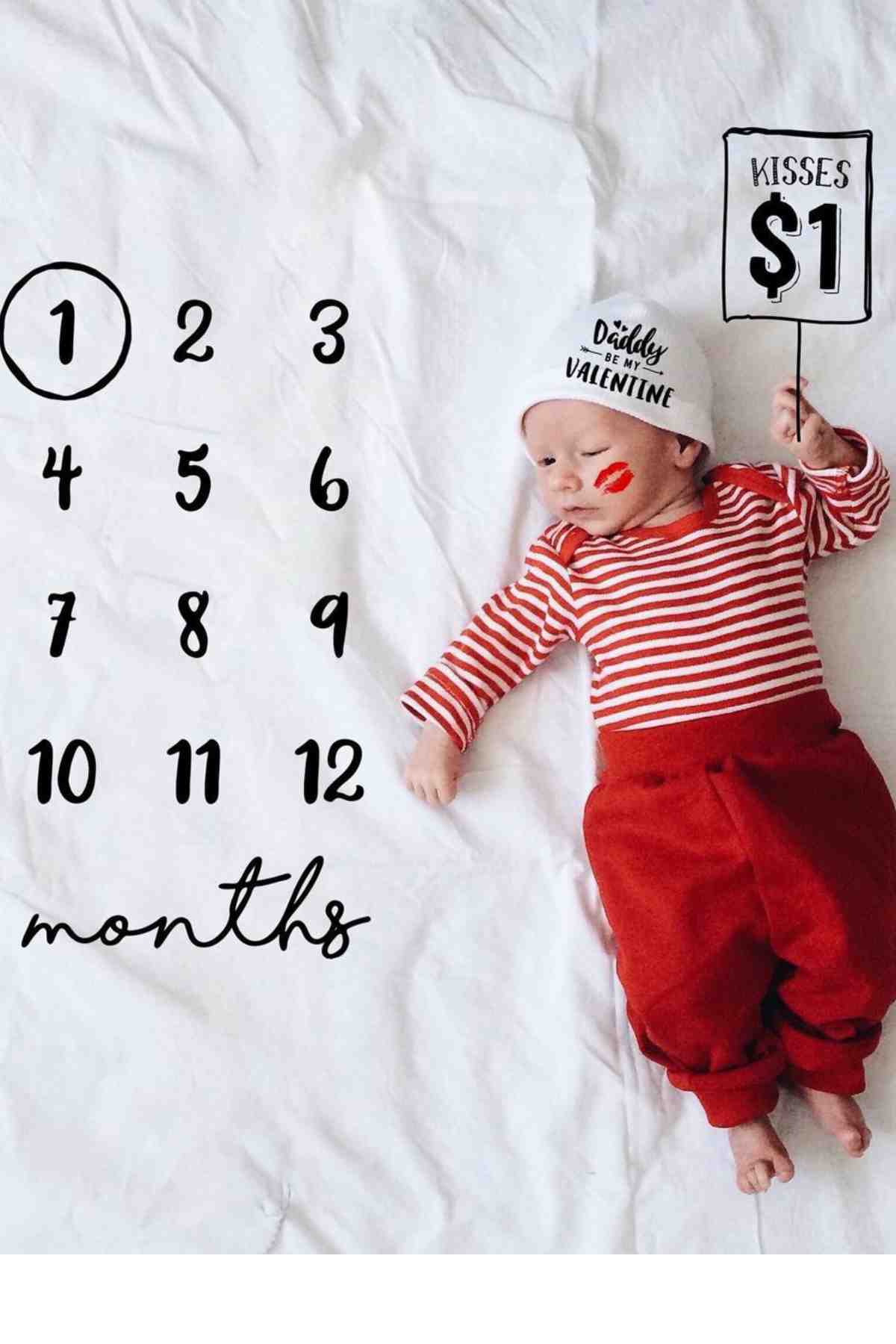 A baby is laying on a bed with a number sign.