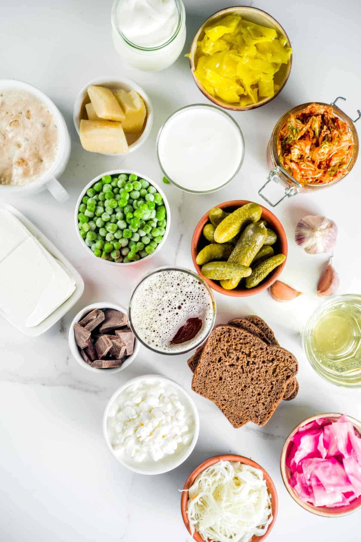 Various probiotic-rich foods displayed on a white surface.