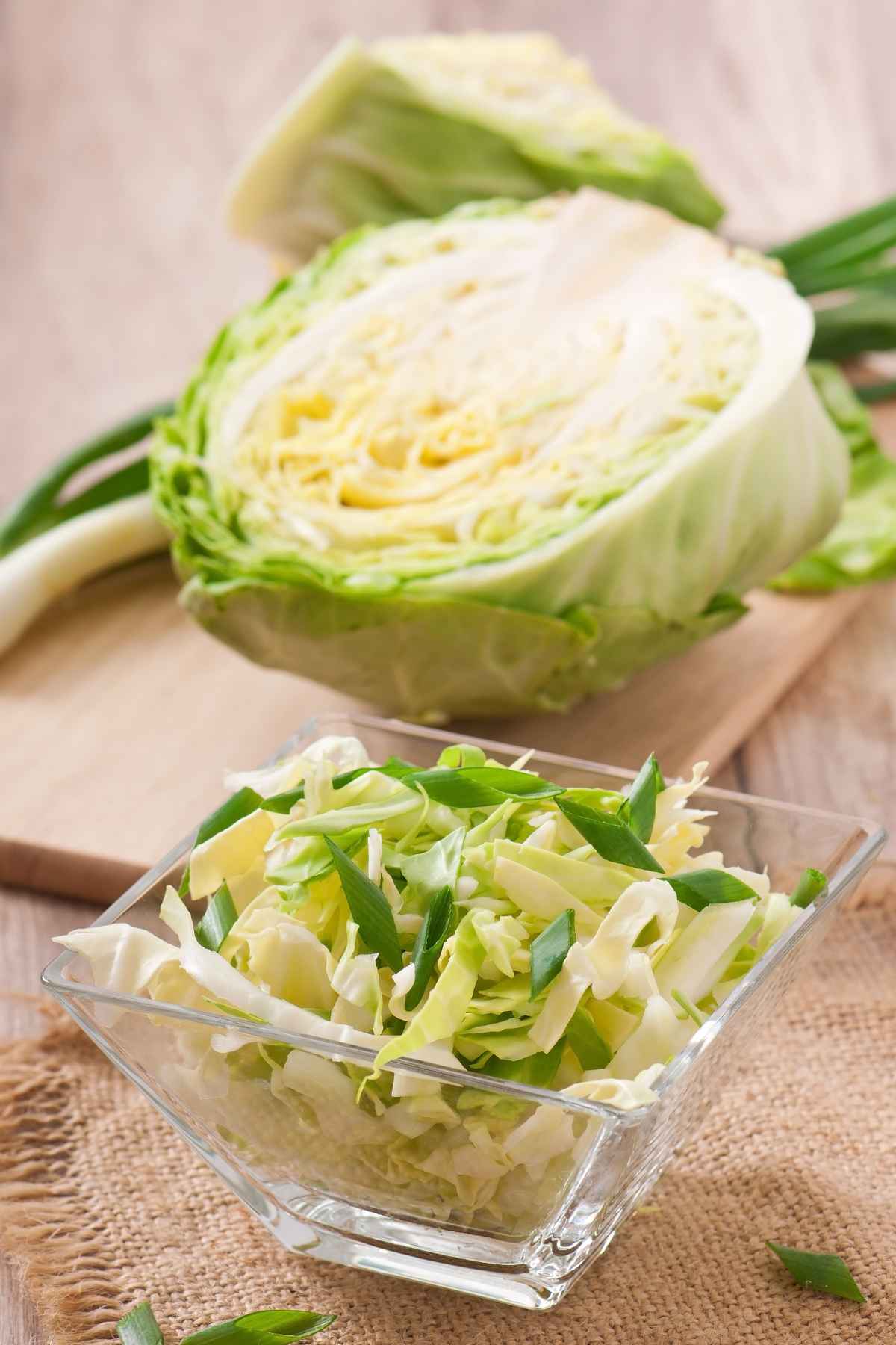 A glass bowl filled with chopped cabbage.