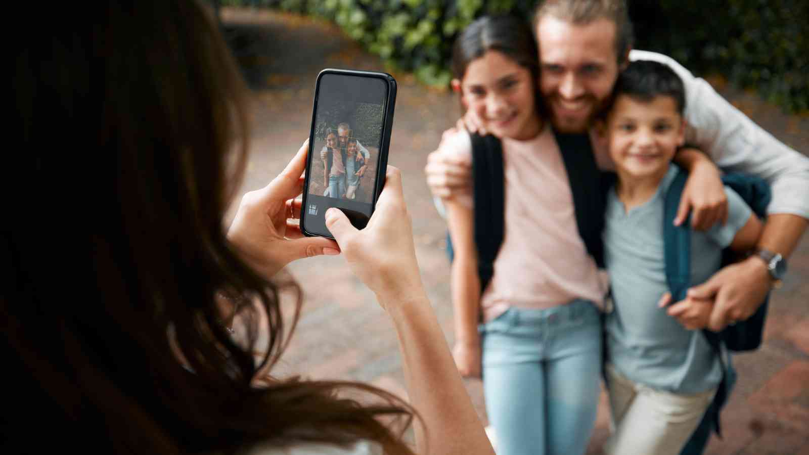 Person taking a father and his kids.