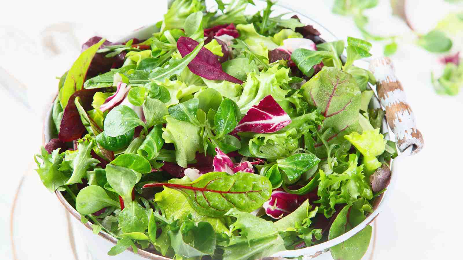 A bowl filled with a beet green salad.