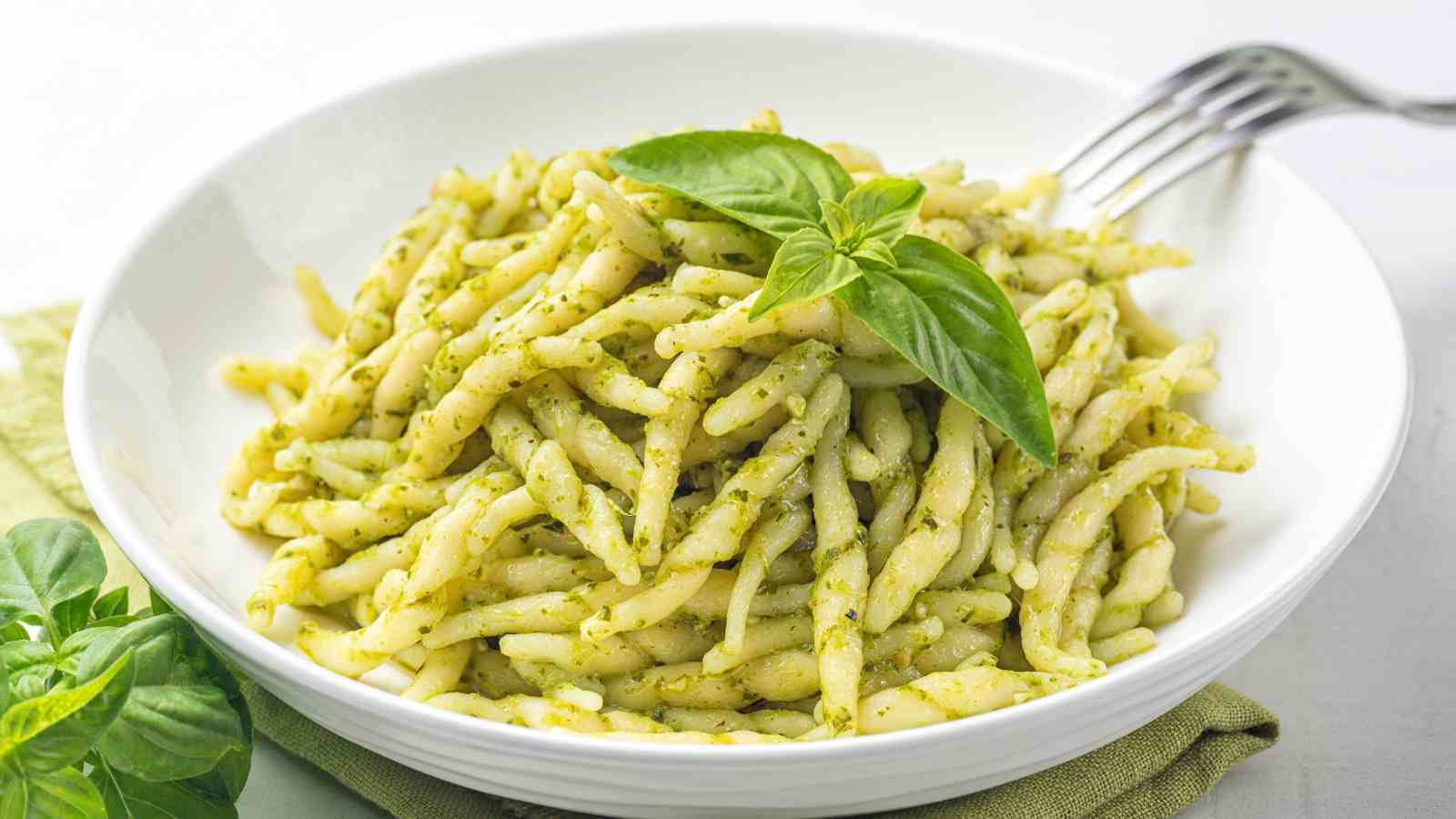 A plate of pesto pasta.
