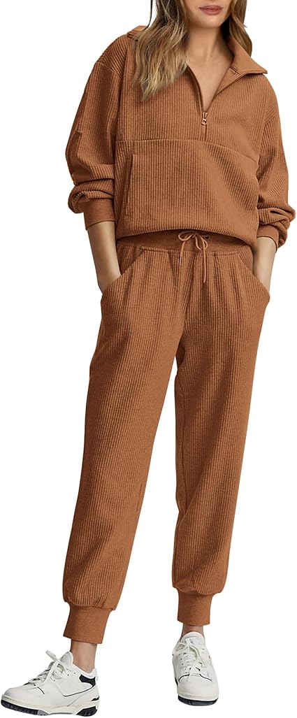 A person wearing a brown ribbed zip-up sweater and matching drawstring pants, paired with white sneakers.