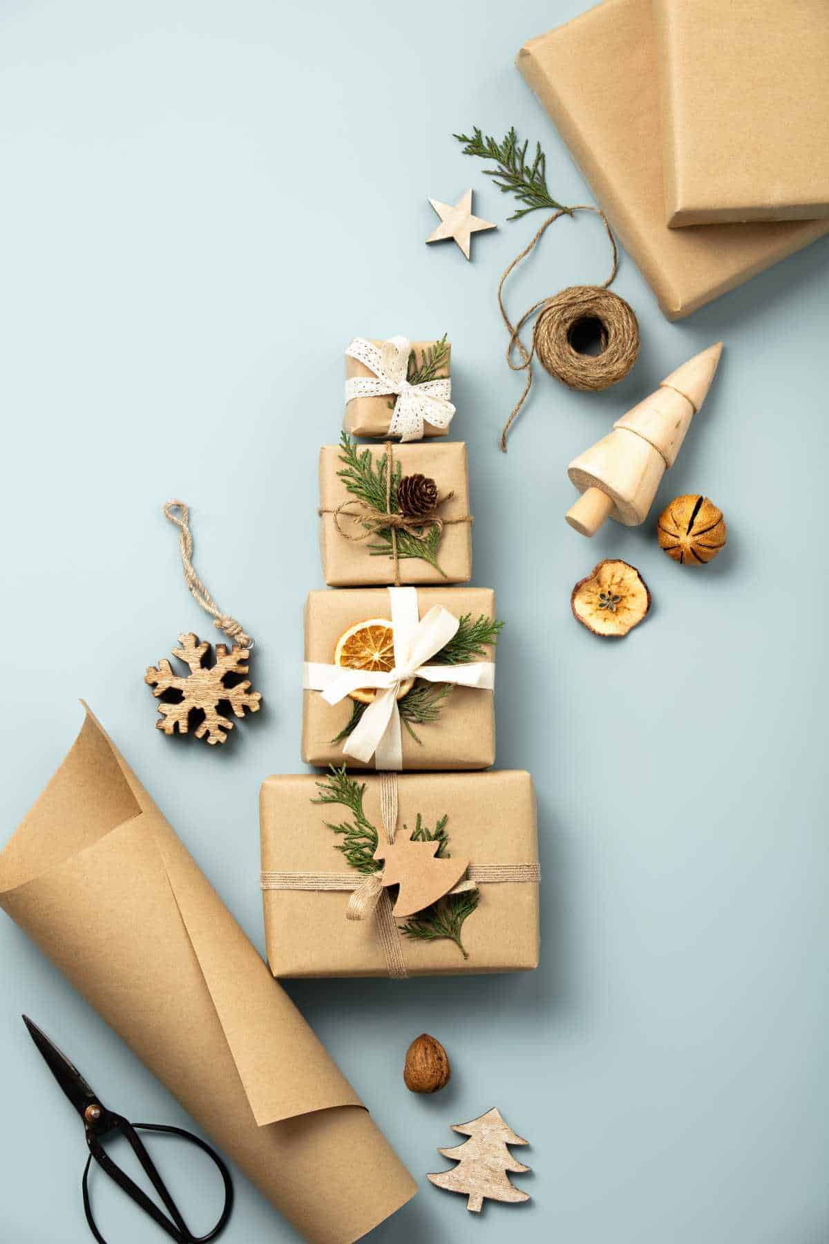 A stack of brown paper-wrapped gifts with eco-friendly Christmas decorations.