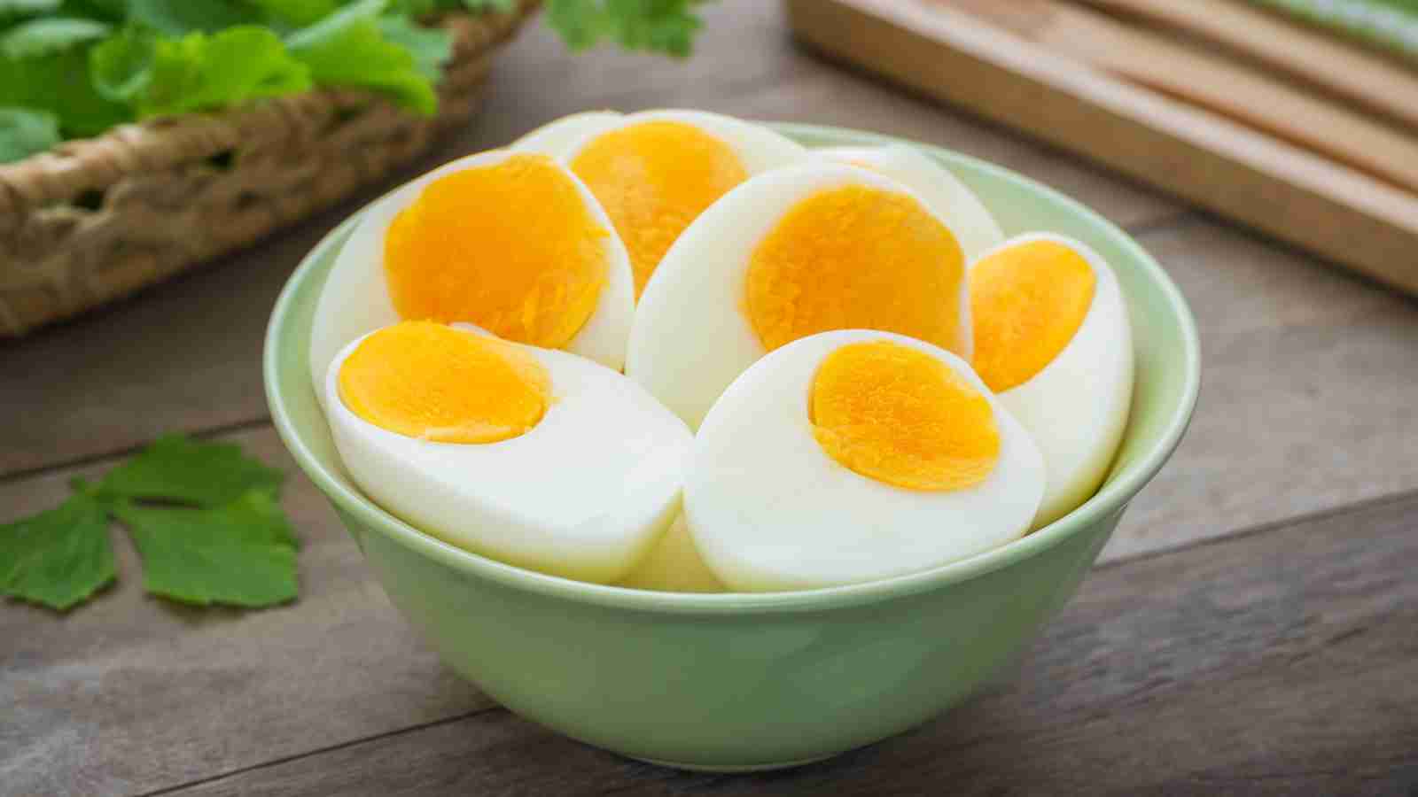 A bowl filled with boiled eggs sliced in halves.