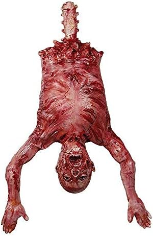 Realistic prop of a flayed humanoid figure hanging upside down, exposing muscles and bones, with arms extended downward.