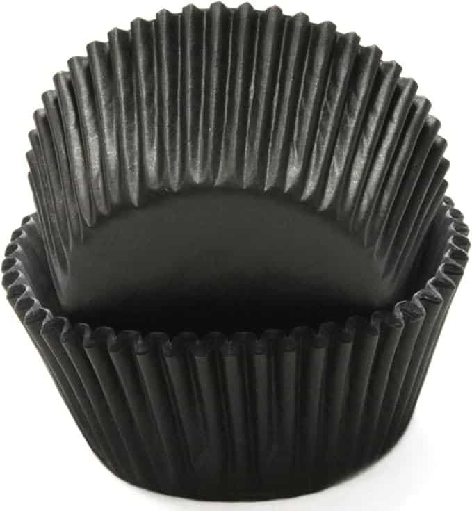 Two black cupcake liners stacked with one partially inside the other.