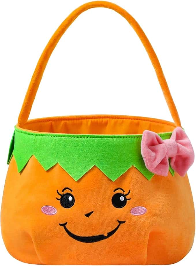 Orange pumpkin-shaped basket with green trim, a smiling face, and a pink bow on the side.