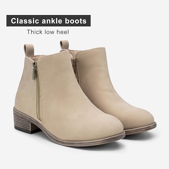 A cream, thick low heeled ankle boots with a zipper on the side.