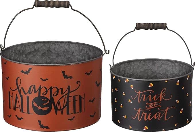 Two metal buckets with handles; one orange with "Happy Halloween" and bats, the other black with "Trick or Treat" and candy corn design.