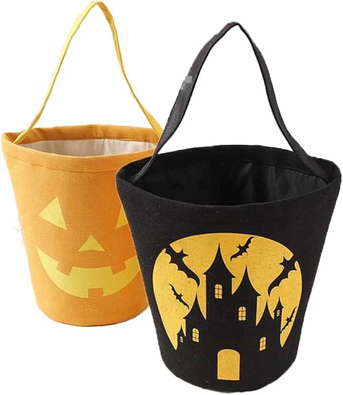 Two Halloween-themed fabric buckets: one orange with a jack-o'-lantern face, the other black with a haunted house and bats design.