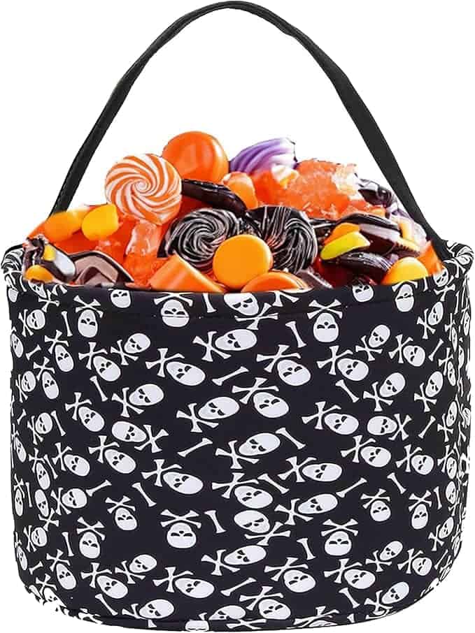 Black basket with skull and crossbones design filled with assorted candies.