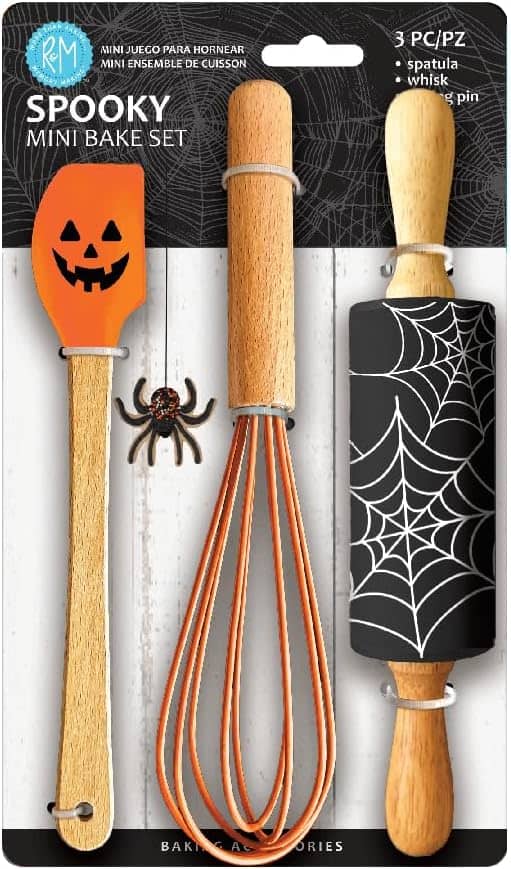 Spooky mini bake set with orange pumpkin spatula, whisk, and rolling pin with black spiderweb design. Includes decorative spider.