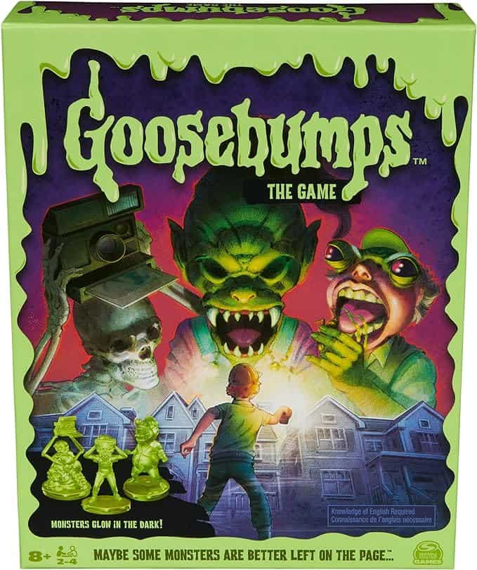 Cover of "Goosebumps: The Game" featuring glowing green monsters and silhouettes in front of a house. Includes small green monster figurines at the bottom.