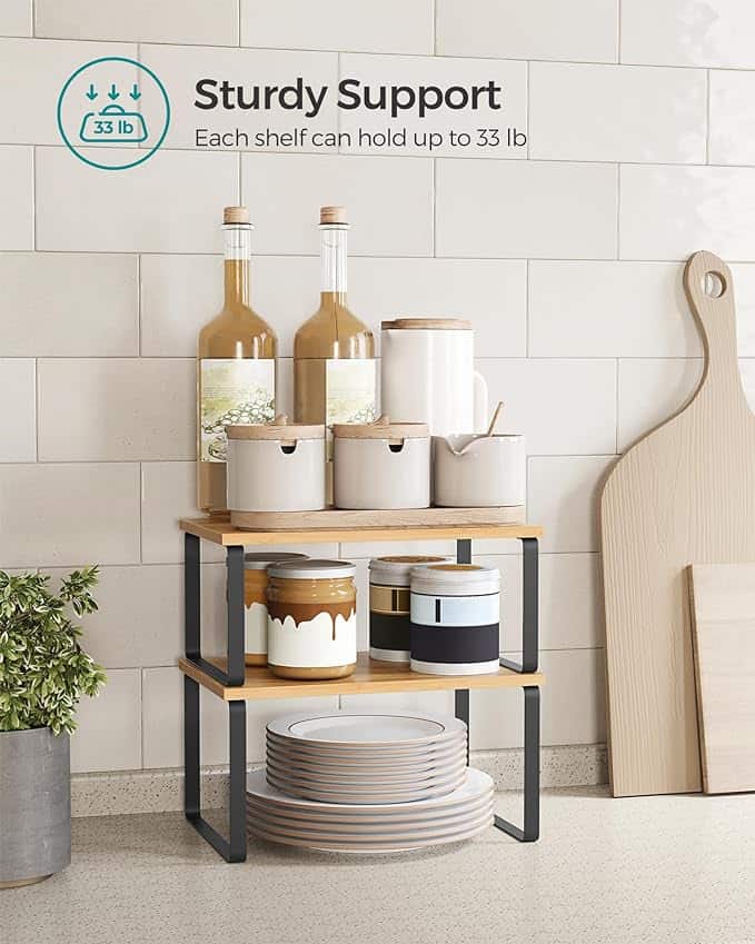 Two-tiered shelf with jars, containers, and plates.