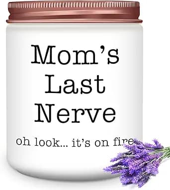 White candle jar with the text "Mom's Last Nerve" and "oh look... it's on fire," adorned with a small lavender sprig.