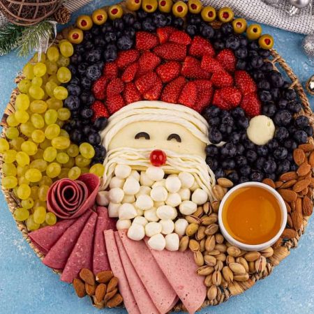 Santa charcuterie board on a blue surface.