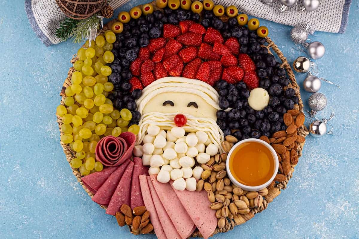 Santa charcuterie board on a blue surface.