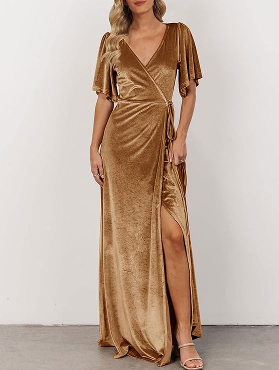 Person wearing a gold velvet wrap dress with short sleeves and a thigh-high slit, standing against a plain background.