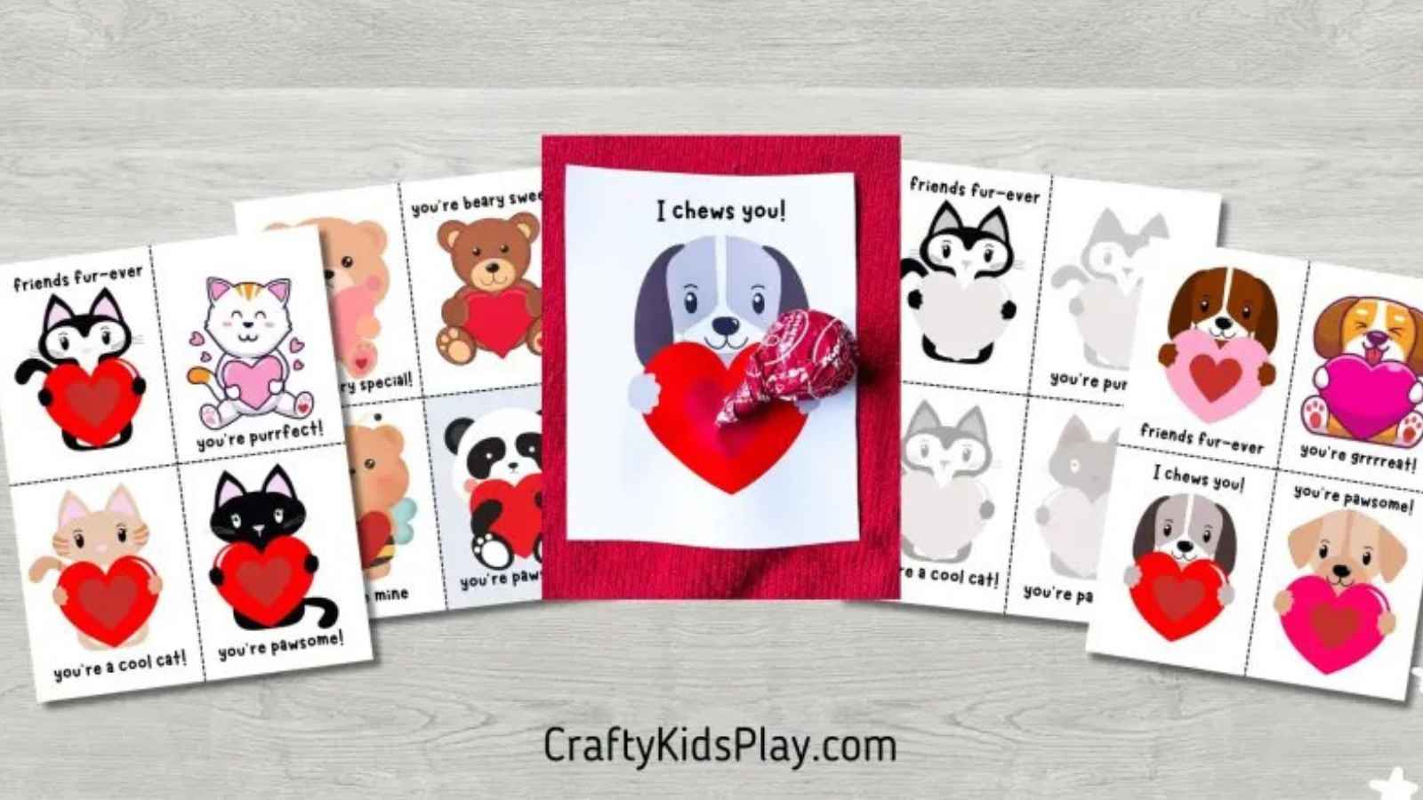 A variety of animal-themed Valentine's cards with cute phrases surround a central card featuring a dog holding a red heart, adorned with a small candy.