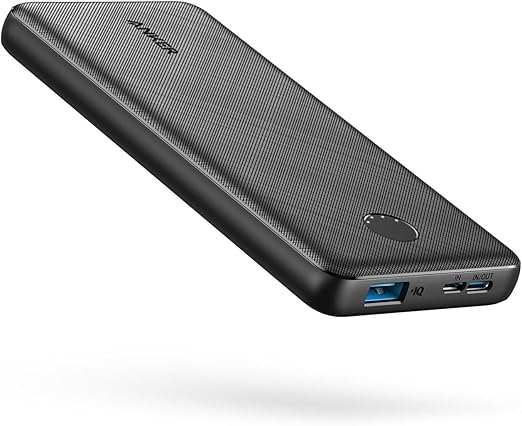 A black Anker power bank with textured surface, featuring USB-A, USB-C, and micro USB ports, floats against a white background.