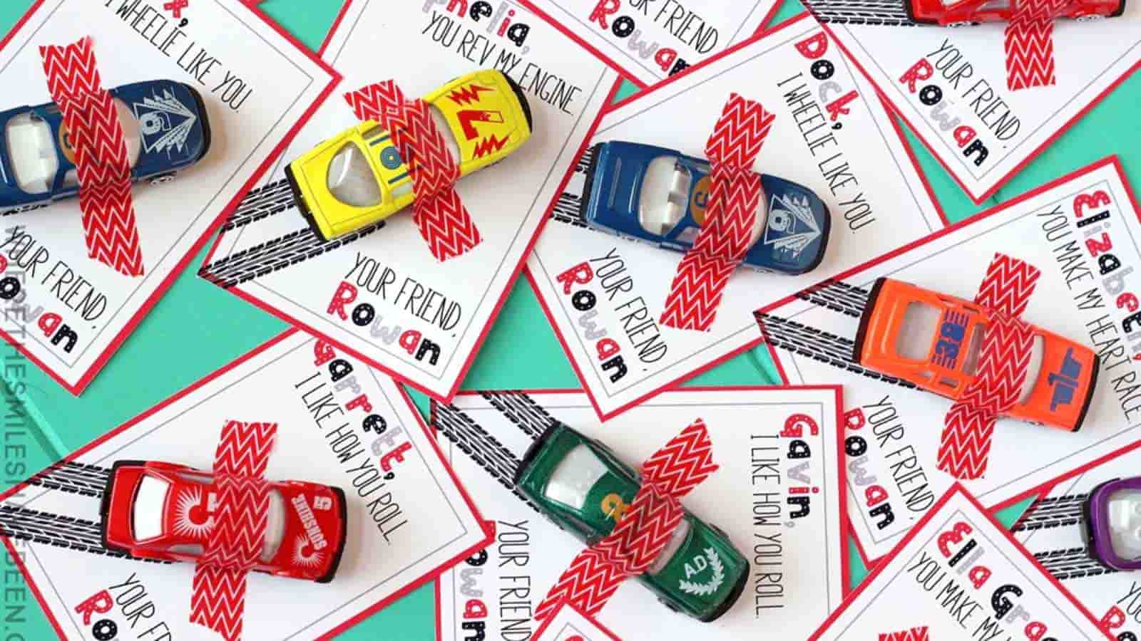 Toy cars on colorful cards with messages like "I wheelie like you" and "You rev my engine," secured by red washi tape.