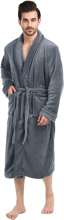 Man wearing a long, grey bathrobe with a tie belt and two front pockets, standing barefoot against a plain background.