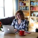 A woman sitting in front of a laptop.