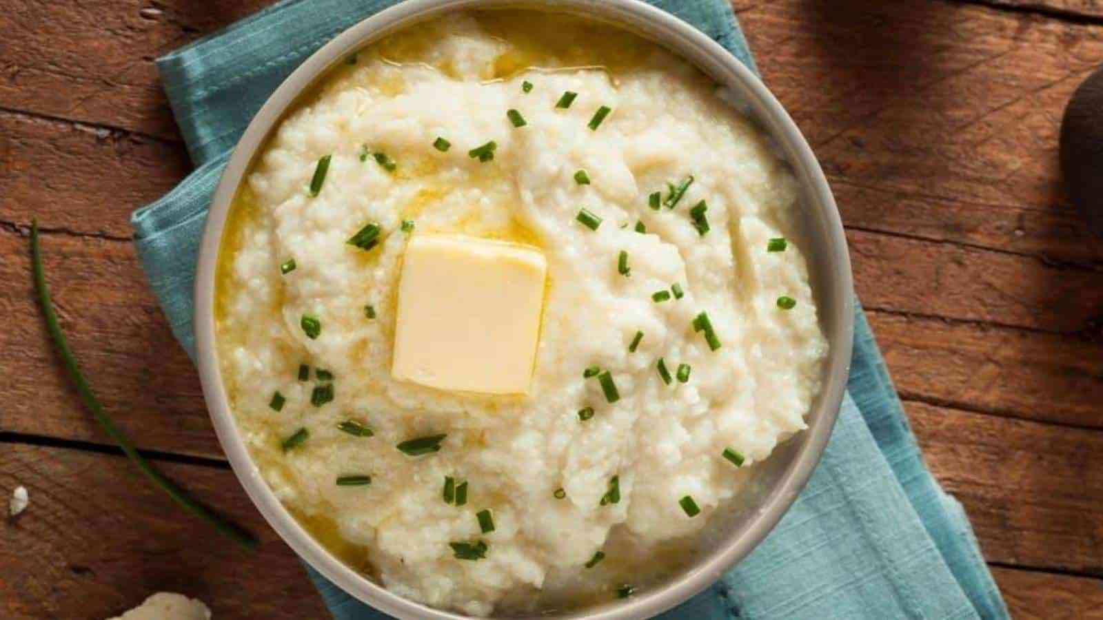Mashed cauliflower potatoes with butter on top in a bowl.