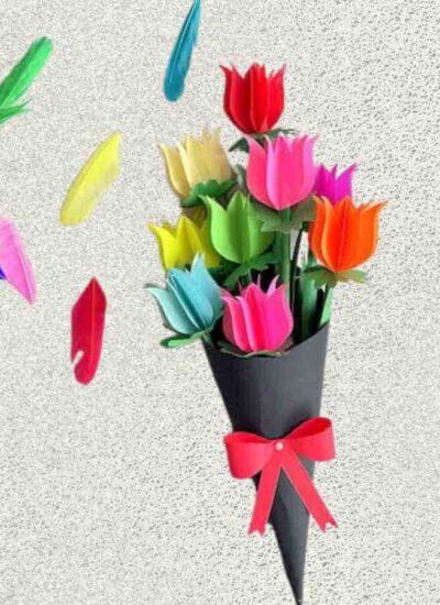 A bouquet of multicolored tulips in a black paper cone with a red bow. Colorful feathers float nearby on a textured background.