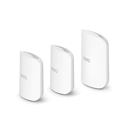 Three white Eero Wi-Fi mesh router units are shown standing upright side by side against a plain background.