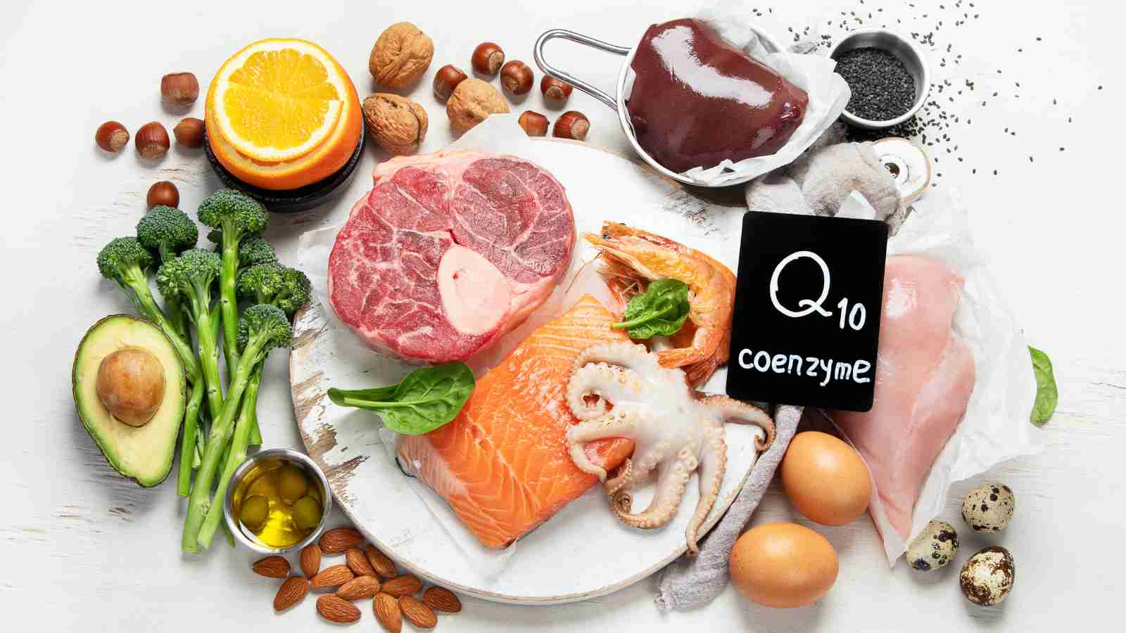 A variety of Coenzyme Q10-rich foods, including meat, fish, seafood, nuts, and vegetables, are arranged around a small chalkboard with the text "Q10 coenzyme".