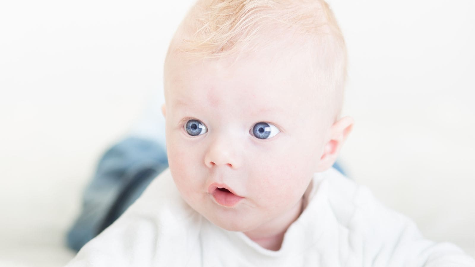 A baby boy with blue eyes and blond hair.